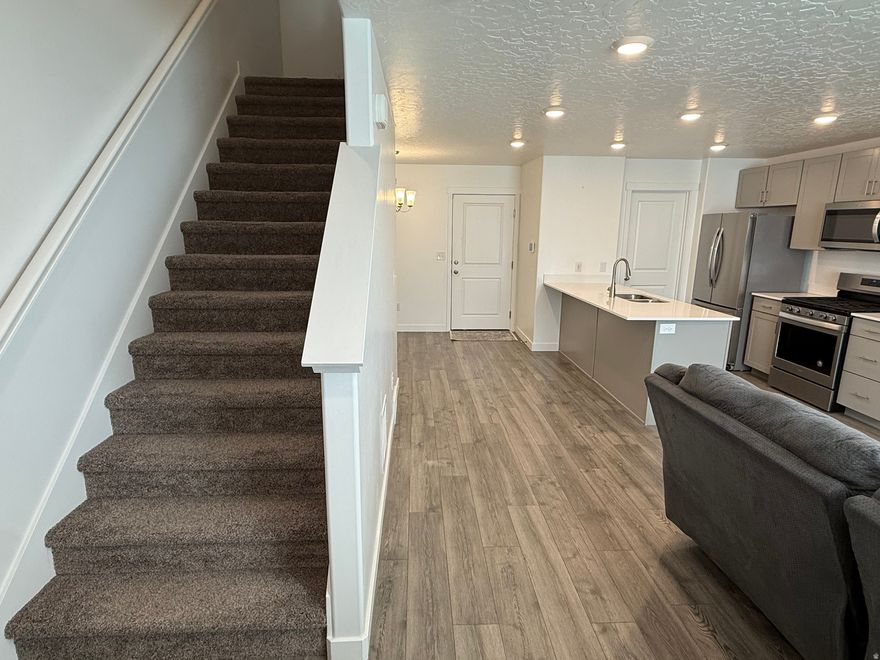 Modern 3-bedroom, 2-bath townhome featuring tall ceilings, a sleek kitchen with quartz countertops, bright and airy interiors and an integrated smart-home system for connected living. Walking distance to an amazing clubhouse, large pool, pickleball court, dog park, playgrounds and more! This home is one of the very few with a full basement of flex space - home theater or gym? Epoxy floor in garage! All appliances stay so it's ready to move in today!