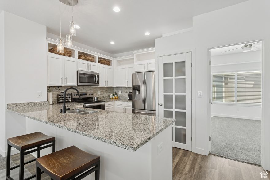 Discover the lifestyle you've been dreaming of in this beautifully designed home, situated in one of Bluffdale's most desirable neighborhoods. You'll enjoy the convenience of being within walking distance to top-rated schools, lush parks, and scenic walking trails, making it a perfect blend of comfort and community.  Take advantage of the neighborhood swimming pool, high-speed fiber internet, and other fantastic amenities-all covered by low HOA dues. Whether you're working from home or hosting friends, this home has everything you need for a balanced lifestyle.  The open-concept kitchen and great room bathe in bright, natural light, creating an inviting space for relaxation or entertainment. You'll love the luxury of quartz countertops, stainless steel appliances, and modern finishes throughout the home.  With spacious bedrooms and two full bathrooms, everyone can enjoy their own retreat. A conveniently located laundry area adds ease to your daily routine.   This home is vacant, sparkling clean, and ready for its next chapter-all it needs is you! Don't miss the opportunity to own a modern home in a thriving, vibrant community!