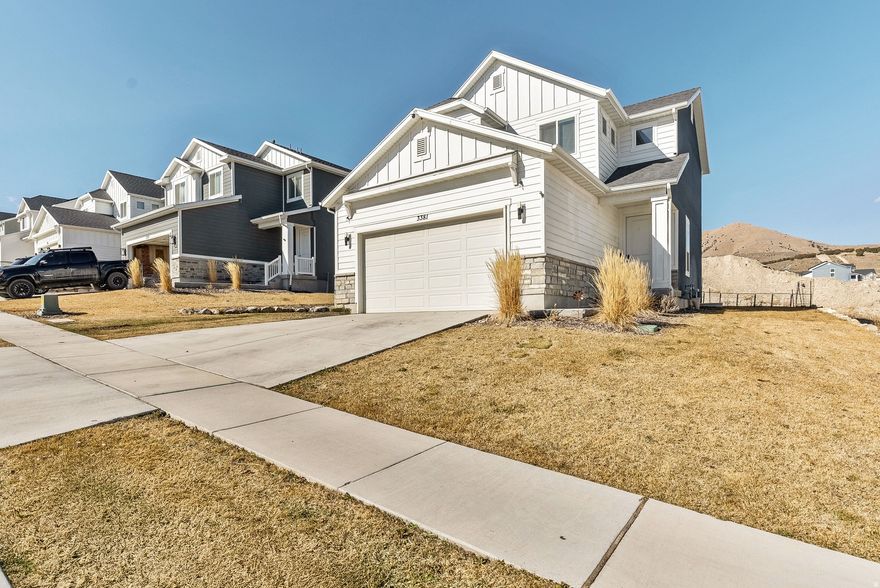 Bright, welcoming, and well maintained, this newer home offers comfortable living with clean, modern finishes and a layout designed for everyday ease. Large windows and an open floor plan fill the main living areas with natural light, creating a warm and inviting space for gathering, relaxing, and entertaining.  The kitchen features attractive cabinetry, a spacious island, and stainless appliances that complement the home's bright and open living space. Built-in shelving and an electric fireplace add character and functionality to the living room while maintaining the home's bright, open feel.  Upstairs living areas are comfortable and thoughtfully arranged, while the insulated basement includes electrical outlets throughout and is ready to be finished to the buyer's vision-whether additional living space, bedrooms, or a home office.  This property stands out with full RV hookups, including 30 amp electrical and sewage access-an increasingly valuable and hard-to-find feature. The garage is designed for usability, featuring built-in shelving for organized storage and plumbing for a large air compressor, creating an ideal setup for hobbies or workspace needs. A workbench is currently installed and may be included.  Additional highlights include smart home features such as lighting, locks, doorbell, and temperature control, along with a hardwired security camera system that includes a doorbell camera, garage camera, front yard PTZ camera, and back yard camera with local storage for approximately three weeks of 24/7 footage. An installed alarm system provides coverage on both the main level and basement for added peace of mind. A water softener system is also already in place, offering convenience and efficiency for everyday living.  Outside, the property offers full landscaping with an automatic watering system and a manageable yard that provides outdoor space without heavy maintenance. RV parking along the side of the home adds additional flexibility.  Located in a growing neighborhood with a nearby park and quick access to shopping, gas, and everyday conveniences just outside the community.  Ideal for buyers seeking efficiency, organization, security, and practical upgrades. A move-in-ready option with added features and improvements not typically found in standard new construction.  Some images have been digitally enhanced to illustrate potential landscaping.