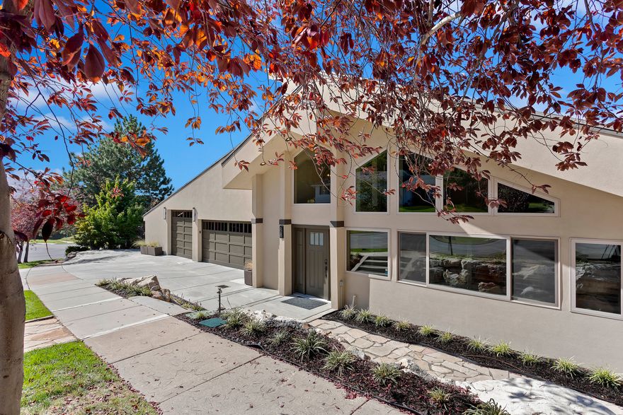 Perched high in the coveted Moss Hill neighborhood, this 7,073 sq ft estate blends elevated design with unforgettable valley views. Soaring vaulted ceilings with exposed beams, statement lighting, and walls of windows flood the home with natural light while framing the landscape below.  At the heart of the home, the remodeled chef's kitchen is both stunning and functional-featuring quartz countertops, custom cabinetry, double wall ovens, a gas cooktop, and an oversized island that flows effortlessly into the great room and dining space. Entertain with ease or step outside to the private deck and take in the sweeping city views.  The primary suite is a true retreat, complete with balcony access and a spa-inspired ensuite showcasing dual vanities, a soaking tub, and a beautifully tiled walk-in shower.  The walkout lower level offers a fully equipped mother-in-law apartment with its own kitchen and living space-perfect for multi-generational living, guests, or strong income potential.  Car enthusiasts, hobbyists, or anyone needing space will appreciate the expansive garage, complete with a dedicated workshop area and abundant storage-offering both function and flexibility rarely found at this level.  With 5 bedrooms, 5 bathrooms, and over 7,000 square feet of thoughtfully updated living space, this is more than a home-it's a lifestyle in one of the area's most sought-after settings.