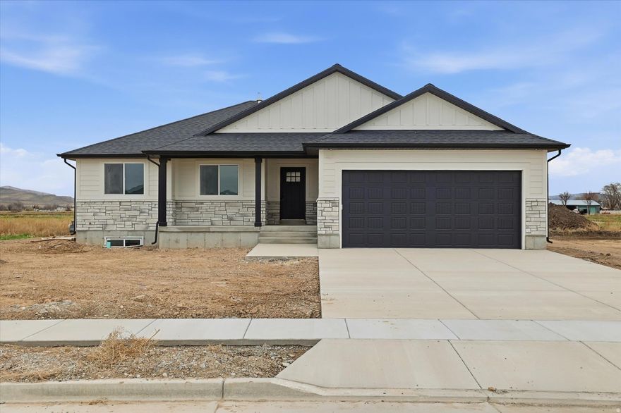 Brand New Rambler in Eastside View!   Welcome to this beautifully crafted 3-bedroom, 2-bath home in the desirable Eastside View subdivision of Garland, Utah. Featuring a spacious open-concept floor plan, vaulted ceilings, and abundant natural light, this home is perfect for modern living. The kitchen boasts stylish finishes, ample counter space, and a functional layout that flows seamlessly into the dining and living areas. Enjoy the comfort of a private primary suite with a walk-in closet and ensuite bath. Exterior highlights include an attractive rock and vinyl finish, a 2-car garage, and a prime lot with scenic views.   Act now and you may still have time to choose select colors and finishes to make this home uniquely yours! No HOA means more freedom to enjoy your property your way. Conveniently located near schools, parks, and all that Box Elder County has to offer!