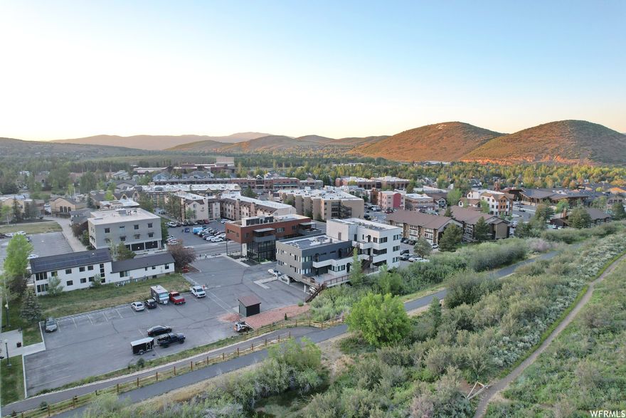 Welcome to the most upgraded studio in Carriage House - fully remodeled in 2023 and the only unit in the building with a dedicated heat pump for both heating and air conditioning, a rare luxury in Park City. You'll also enjoy the building's only ground-floor walk-out patio, a private semi-enclosed outdoor space accessible via sliding glass doors - perfect for gear storage, morning coffee, or winding down after a day on the mountain. Inside, everything is fresh: LVP flooring throughout, dark cabinetry with butcher block counters, stainless appliances, and an updated bath. The unit is turnkey and fully furnished with two queen beds - ready for personal use or immediate rental income. Short-term rentals are permitted with no rental cap. Located steps from the free Park City transit line with direct access to Main Street, PCMR, and Deer Valley. The Historic Rail Trail runs adjacent to the building. HOA covers water, sewer, trash, and snow removal at just $286/month - one of the lowest HOA fees in the Prospector Square area. Building amenities include a heated outdoor pool, indoor hot tub/spa, fire pit, and on-site laundry. Seller financing available - call agent for details. Square footage figures are provided as a courtesy estimate only and were obtained from County Records.  Buyer is advised to obtain an independent measurement.