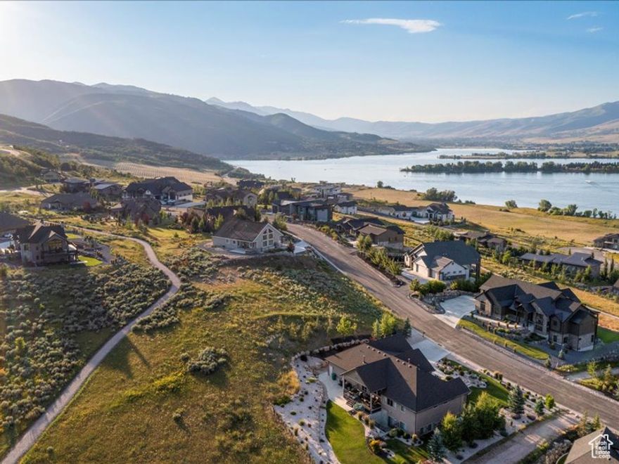 Perched in the thoughtfully designed Edgewater Chalets community, Lot 54 offers the ideal blend of mountain adventure and lake living. Located at the base of Old Snowbasin Road and Highway 39 in Huntsville, UT, this lot puts you just minutes from skiing at Snowbasin, biking and hiking scenic trails, or enjoying water sports at Pineview Reservoir. A completed geotechnical study adds confidence for future building plans. The subdivision's Architectural Control Committee ensures that view corridors are preserved and that home designs complement the natural beauty and cohesive aesthetic of the neighborhood. With stunning views of Pineview and Snowbasin, this lot is your chance to build the perfect four-season retreat in the heart of Ogden Valley. Boundary lines are provided as a courtesy estimate only. Buyer is advised to obtain an independent measurement.