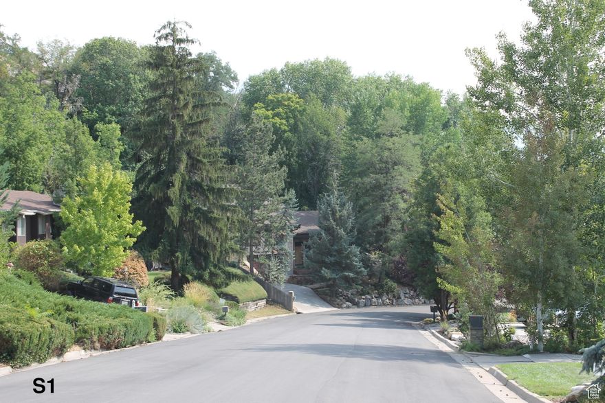 Extraordinary opportunity in Holladay for an investor, flipper, or DIY buyer. This property in mid-construction of a significant remodel offers a blank canvas to create your vision. Situated on a 0.46-acre lot with mature trees and valley views, the setting is private and picturesque. An adjacent parcel (0.16 acres) can also be purchased, expanding to 0.62 acres and allowing for an ADU or office, pool house, etc.  (Geotech for ADU is approved by the city). The home offers vaulted ceilings in nearly every room, including an impressive Great Room/Kitchen with 18' ceilings. This area, along with the adjacent Bath/Pantry/Laundry, is currently unfinished. The rest of the home is complete, though some new finishes will be desired. Because conventional financing is not an option until completion, sellers may consider creative options or partnerships to facilitate completion. Seller is an architect and has developed concept plans for alternative uses including an external ADU plan, and a fully accessible senior living facility with up to 8 residents (a permitted use). Review the site plans, floor plans, photos, and renderings to see the possibilities this unique property offers.