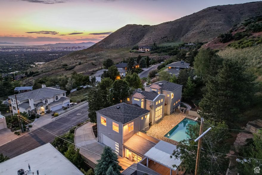 Don't miss the DRONE FOOTAGE in the TOURS section.  An iconic Arcadia Heights residence, this contemporary European 2-story blends unique European architecture with modern sophistication (over $734,000 in recent upgrades!). A stunning kitchen opens to elegant formal dining space with formal living room and wet bar just down the hall, all with impeccable views and rich tiger wood South American hardwood flooring!  The beautifully updated kitchen has views of the valley in front and expansive pool, fountain, and yard in the back! With heated floors throughout, it is perfect for gathering and entertaining. The oversized primary suite is a true retreat, featuring a spacious walk-in closet, a luxurious bath, and direct access to the private balcony overlooking the Salt Lake valley, covering a space for a hot tub and offering direct access to the 38ft x 17.5 ft saltwater pool. A fabulous sitting porch, just below the master deck and in front of the hot tub area also allows for unobstructed valley views. Rare for The Arcadia Heights neighborhood, the .52-acre lot offers valley views but no backyard neighbors, a private pool on the house main level, a firepit, gazebo, upper level patio, and direct access to Arcadia Heights trails out your backyard! All within minutes of Park City, multiple canyons, I-80 and I-215 freeways, SLC airport, shopping, dining, and the vibrant Salt Lake City lifestyle. This house is one-of-a-kind!!  Over $734,000 in recent upgrades! The updated German kitchen with Italian appliances and induction range is unlike any other! Enjoy the heated saltwater pool, (POOL SIZE 38 FT x 17.5 foot 34,000 gallons). Check out the custom updated bathrooms as well as the tiger wood floors that will delight the most discriminating buyers. Incredible valley views and spectacular sunsets await! Private deck off the master!  Central air, 6 mini splits, and radiant flooring throughout for optimum temperature control and comfort. Covered deck, and large patio! Also wired for a hot tub. Walking trails are steps away, right outside the back gate is the Arcadia trail (part of the Bonneville Shoreline Trail System) Mature landscaping creates a very private setting. Call today for a private showing! SEE THE ATTACHMENTS SECTION FOR A LIST OF ALL THE UPDATES AND IMPROVEMENTS!