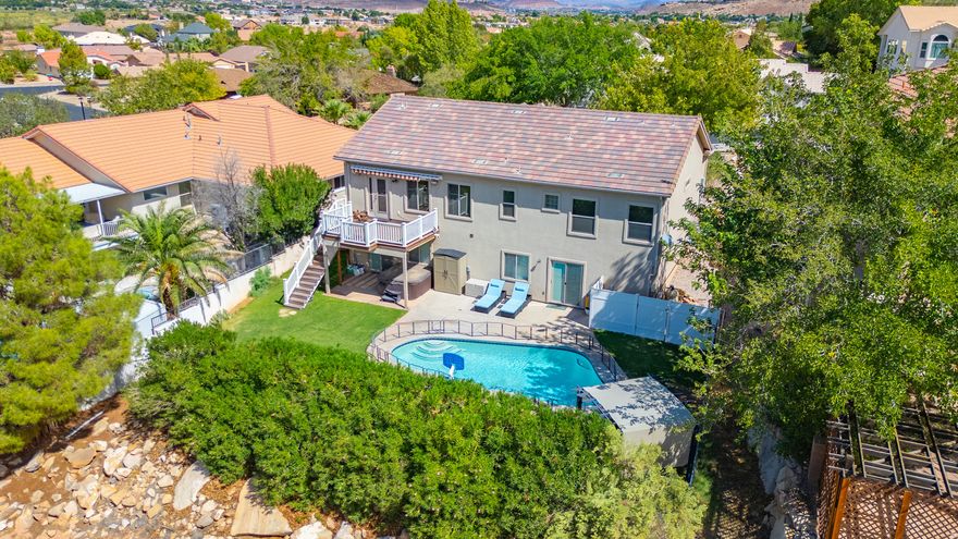 Welcome home to the heart of Bloomington Hills, where Southern Utah living shines. This six bedroom, three bathroom home blends comfort and versatility with plenty of space to entertain, relax, and enjoy the St. George lifestyle.  The backyard is the star of the show, featuring a private pool perfect for sunny afternoons, weekend gatherings, and evening swims under desert skies. Whether you are hosting friends, watching the kids splash, or simply relaxing poolside, this is where memories are made.  Inside, the layout offers flexibility and room for everyone. With six bedrooms, there is space for guests, a home office, gym, or hobby room. The living areas are welcoming and designed for connection, while still offering plenty of separation when you want quiet time.  Located in a desirable area served by Dixie Power, this home offers the benefit of lower utility costs along with quick access to schools, parks, trails, shopping, and dining. Bloomington Hills is known for its established feel, mature landscaping, and easy access to everything St. George has to offer.  If you have been searching for a home that feels like a staycation every day, this one checks all the boxes. Pool, space, location, and lifestyle all come together right here. Come see why this home is the one everyone will be talking about.