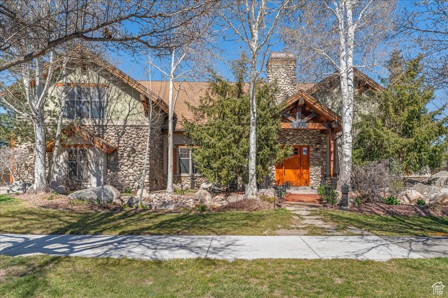 WOW, what a find! This one-of-a-kind South Jordan home blends charm, luxury, and architectural beauty-just 23 minutes from world-class skiing in Little and Big Cottonwood Canyons.  Step inside to soaring 28-foot exposed beams and timbers, a stunning showcase of craftsmanship. A double-sided fireplace warms the great room, creating the perfect spot to relax and admire the crisscrossing woodwork. Brand-new flooring enhances the main level and primary suite.  The spacious primary bedroom offers a private hot tub entrance, huge walk-in closet, and a spa-like bath with a jetted tub, waterfall shower, and multiple sprayers.  The gourmet kitchen-bright, open, and built for entertaining-features under-cabinet lighting, travertine backsplash, high-end stainless appliances including a 6-burner gas range, oversized fridge/freezer, dual sinks, and a central island.  Upstairs, enjoy a cozy family room, two large bedrooms with en-suite baths, and a private theater room. The backyard is an entertainer's dream with a covered timber-framed patio, hot tub, pickleball/hoop court, and mountain-inspired landscaping with aspens, pines, and a charming rock riverbed and bridge.  The oversized heated garage and shop offer abundant storage, a separate entrance, cabinetry, woodworking ventilation, and 220v power for welding or large equipment. Heated floors throughout the home are powered by a new hydronic radiant boiler. Extras include copper gutters, RV pad, double laundry hookups, and attic storage.  Minutes from the freeway, shopping, dining, and entertainment at The District and Mountain View Village-this home has it all. Come experience it in person!
