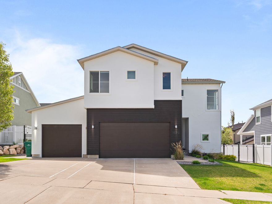 Great location on the Layton/Kaysville border! This modern home features solar, a finished basement, and an oversized 3-car garage. Built in 2014 and meticulously maintained by the original owners, this newer construction home offers flexible living space in a highly desirable neighborhood. Enjoy beautiful mountain views with convenient access to hiking, parks, schools, shopping, and public transportation, including FrontRunner. The open-concept main level showcases a spacious kitchen with quartz countertops, island seating, and seamless flow into the dining and living areas, along with a convenient half bath. Upstairs includes three bedrooms, two full baths, a versatile loft/den (easily converted to a fourth bedroom or additional living space), and a dedicated laundry room. The primary suite features a full bath with dual-sink quartz vanity, a large walk-in closet, and an additional secondary closet. The finished basement includes a three-quarter bathroom and epoxy-sealed concrete floors, providing flexible space for a gym, recreation area, media room, or play space. The fully fenced and landscaped backyard offers a large grassy area, pergola-covered patio seating, fire pit area, and low-maintenance rock landscaping and is perfect for relaxing or entertaining. Recent updates include fresh exterior paint and thoughtful maintenance throughout, contributing to the home's clean, move-in ready feel. Additional features include solar, a tankless water heater, and a fresh-air HEPA exchange system for added comfort. Homes that offer this combination of modern layout, usable space, and outdoor living in this location are rarely available.