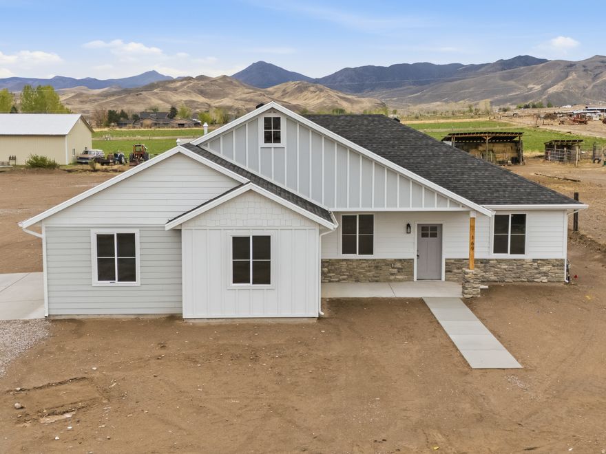 Welcome to 169 W 100 S in Joseph, a beautifully crafted brand-new single-level home located in the quiet and scenic community of Joseph, Utah. Set on a generous 0.51-acre lot along a peaceful road, this property offers the perfect balance of modern living and rural tranquility.  This home features 4 bedrooms and 2 bathrooms with a thoughtfully designed open floor plan and elegant finishes throughout. The kitchen is both stylish and functional, highlighted by a unique hidden walk-in pantry that adds a custom touch you won't find every day. A covered patio extends your living space outdoors-ideal for relaxing or entertaining while enjoying the surrounding landscape.  Additional amenities include a 2-car garage and a shared driveway for convenient access and easy maneuverability.  Perfectly positioned for outdoor recreation, you'll be just minutes from biking and walking paths, as well as endless mountain trails, hunting, and fishing opportunities.  This home offers the same well-designed floor plan as the neighboring property, featuring a mirrored layout with its own distinct color scheme-providing a similar design with a fresh, unique feel.  Take advantage of this opportunity to own a brand-new home in a peaceful setting with unmatched access to Utah's great outdoors.