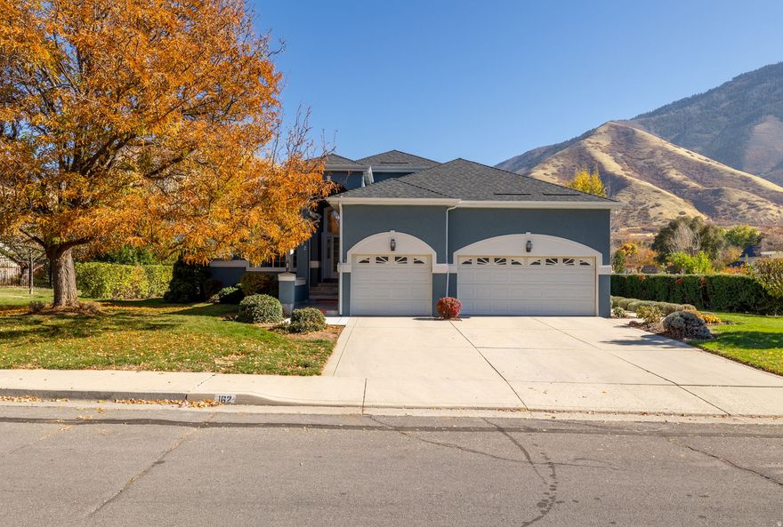 Located in beautiful Mapleton, Utah, .37 acre, 4,040 sq ft, 5BR/3BA home with spectacular mountain backdrops!  Stunning new stucco, 3 car garage, covered raised patio and lush private yard with mature landscaping.  Covered front porch with transom window above the front door.  Step into charming elegance with a roomy front entry.   Beautiful vaulted ceilings, gorgeous hardwood flooring and a spacious bright and open floor plan!   Large great room w/gas fireplace, back yard access and wonderfully updated kitchen.  Granite countertops, large island, gas cook top, lots of gorgeous cabinetry, built-in desk, lots of can lighting and large bright and open dining nook!  The primary suite includes private patio access, walk-in closet, nicely updated master bath w/LVP flooring & double vanities for added convenience.  A key feature in this home is the dramatic walk-out basement, which contains a huge family room with direct access to the back yard.  This home is designed for main floor living offering laundry upstairs and a huge laundry room downstairs.  Downstairs also features two more bedrooms, a full bath and a large storage room w/built in shelving!  This home is a complete package, offering generous space and functional updates all in a prime location!