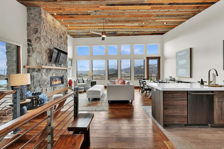 The luxury mountain-modern townhome you've been waiting for - this fully furnished end-unit townhome has never been used as a rental, and is in truly pristine condition! Professionally furnished with high-end, bespoke pieces throughout - from custom window shades and drapes, impeccable hardwood floors, designer curated bedrooms, and an over-sized outdoor jacuzzi - no detail has been overlooked. As you enter through the front door you'll find a tastefully furnished living room, custom barn wood ceiling, and spacious kitchen featuring lightly used Thermador professional-grade appliances. A floor to ceiling rock fireplace with mantle is perfect for enjoying winter nights in comfort. A private deck, accessible from living room and primary bedroom, offers breathtaking, unobstructed views of the surrounding mountains, lake, and valley floor. The primary suite offers ample space to relax, and bathroom features heated floors, custom barn door slider, oversized glass/tile shower, and a deep soaking tub that has never been used. A mud room off the 2-car garage features a washer/dryer and a custom bench and coat rack for storing winter clothing. On the lower level you will find an additional living area with custom dry-bar, an additional floor to ceiling rock fireplace, 3 more bedrooms each with their own en-suite bathrooms, and a large theatre/game room. These lower level bedrooms have seen very light use, some beds have never been slept in! Step onto the oversized walkout cement patio and enjoy sweeping mountain and valley views while you relax in your high-end Bullfrog jacuzzi. This Ridge townhome is located just steps from the HOA plunge pool and jacuzzi, a shuttle stop to Powder Mountain, and just a few minutes drive to Wolf Creek Golf Course, Nordic Valley, Snow Basin ski resort, Pineview Reservoir, and miles of hiking and biking trails.