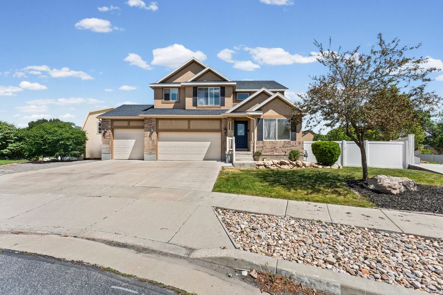 Welcome to this stunning Stansbury Park two-story home, perfectly nestled in a quiet cul-de-sac and offering the rare combination of a three-car garage and RV parking that today's buyers dream about. From the moment you step inside, a dedicated front office sets the tone for effortless work-from-home living, while soaring ceilings, a ceiling fan, and an abundance of natural light make the main living area feel warm, grand, and immediately inviting. The kitchen is nothing short of a chef's paradise, boasting a large center island with bar seating, stunning quartz countertops, a charming rustic backsplash, stainless steel appliances, and generous cabinetry that makes storage a non-issue. The kitchen flows seamlessly into a semi-formal dining area and opens through a sliding glass door onto an expansive deck, ideal for summer barbecues and outdoor entertaining. A convenient half bath and a main-level laundry room with ample cabinetry round out the thoughtfully designed main floor. Upstairs, the oversized primary suite is your personal retreat, featuring a ceiling fan, incredible natural light, a massive walk-in closet, and a luxurious en suite complete with modern flooring, a large separate shower, and a deep soaker tub built for unwinding. Three additional bedrooms and a full bathroom complete the upper level, offering plenty of space for family or guests. Downstairs, the daylight basement truly elevates this home's versatility, featuring a spacious second family room, an additional bedroom, a full bathroom, and its own private entrance, making it an ideal candidate for a mother-in-law apartment or income-producing suite. Outside, the backyard is an entertainer's dream with a large deck, a generous side yard where kids can roam freely, a fully fenced perimeter, and an absolutely massive shed that offers extraordinary storage for tools, toys, and everything in between. This home is truly one of a kind. Schedule your private showing today. Buyer and Buyers agent to verify all information. Square footage figures are provided as a courtesy estimate only. Buyer is advised to obtain an independent measurement.