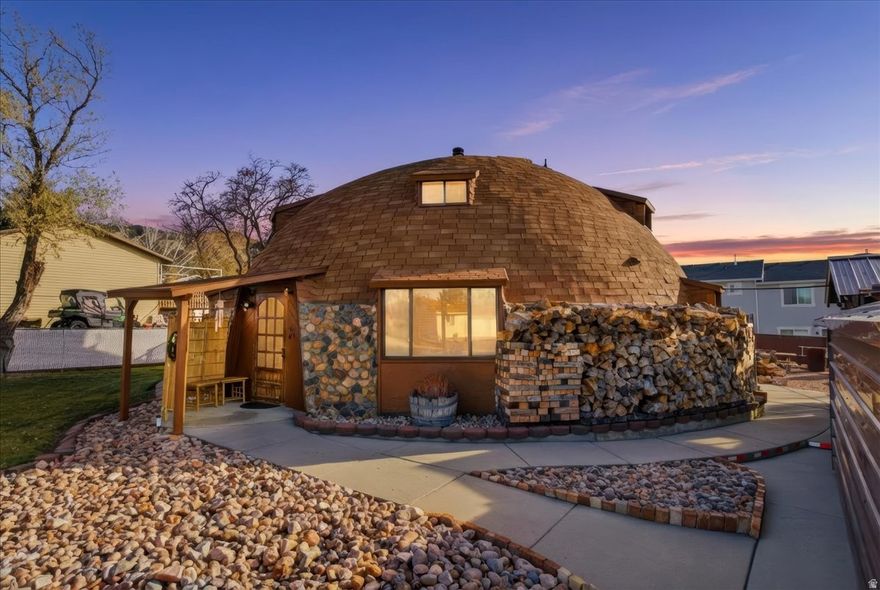 Rare opportunity to own one of the most unique and architecturally distinctive homes in Central Utah. This impressive round home offers 4 bedrooms, 2 bathrooms, and approximately 2,400 square feet of comfortable living space, thoughtfully designed for efficiency, durability, and versatility. Constructed with 24-inch cement walls, 6 inch cement roof and 1/2 inch rebar, the home provides outstanding insulation, sound reduction, and energy efficiency-helping maintain comfortable interior temperatures year-round while keeping utility costs remarkably low. The functional floor plan includes a formal living room plus two additional family rooms/bonus areas, offering flexible space ideal for entertaining, home offices, recreation, or multi-generational living.  All kitchen appliances, washer and dryer, chest freezer, sauna and two safes are included. Recent mechanical updates add significant value and peace of mind, including a new water heater installed in 2017 and a new forced-air heating system and updated electrical panel completed in 2023.  There is also a wood stove with approximately 4 years of wood that will be included. The exterior is equally appealing, featuring a well-maintained, landscaped yard with a balanced combination of green lawn and xeriscape for low-maintenance living. The spacious back patio is an entertainer's dream, complete with a picnic table, swing, and ample room for outdoor dining, gatherings, or relaxation. Two utility sheds provide convenient additional storage for tools, equipment, or seasonal items.  Large RV parking area. A must-see home for buyers seeking something special. Sellers are moving out of state and are very motivated!  *Offers are being accepted until December 23, 2025 at 10am.* Email offers and preapproval letter to kerryanderson8@gmail.com