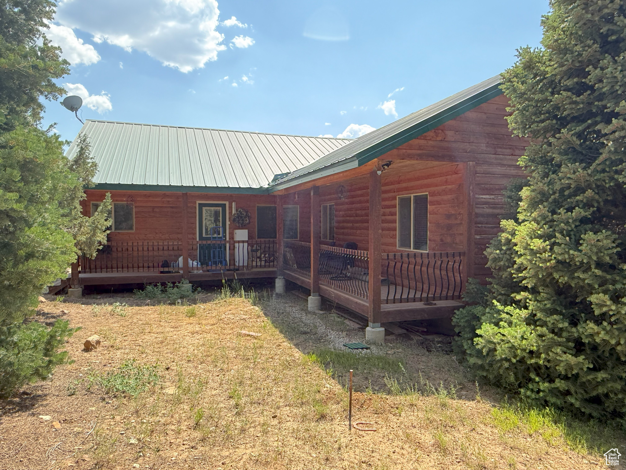 This mountain cabin/home has 3 bedrooms and 2.5 bathrooms on 1.1 acres and includes culinary water via the community water system, electricity from Rocky Mountain Power, and optional internet service. Take in breathtaking views from three spacious decks and the large windows throughout. The great room features vaulted ceilings, oversized windows with amazing views, and a cozy pellet stove. The owner's suite boasts vaulted ceilings and an ensuite bathroom featuring a separate shower, jetted tub, and dual sinks. While it's technically considered a crawl space because of its dirt floor, the crawl space area has an impressive 8-foot ceiling and measures approximately 50 by 13 feet. It also features a beautifully finished woodshop, ideal for projects and hobbies. The property is accessible by car during snow-free months, with winter access via snowmobile or tracked ATV. Conveniently located just over an hour from Provo and only 15 minutes from Mt. Pleasant, where you'll find all the small-town essentials-gas stations, restaurants, grocery and hardware stores, a hospital, and even a nostalgic drive-in theater. Outdoor enthusiasts will appreciate the nearby access to extensive ATV trails, as well as opportunities for fishing, hiking, biking, and hunting. The Pine Creek Ranch POA includes access to a 70-acre common area featuring campsites on the stream, pavilion, sand volleyball court, horse corrals, horseshoe throwing pit, and an area that can accommodate many RVs or trailers. The main parking area is plowed during winter months, although the roads themselves are not. Included in the amenities are water service, trash removal, and upkeep of the private roads and entry gates. Square footage figures are provided as a courtesy estimate only and were obtained from the county records. Buyer is advised to obtain an independent measurement.