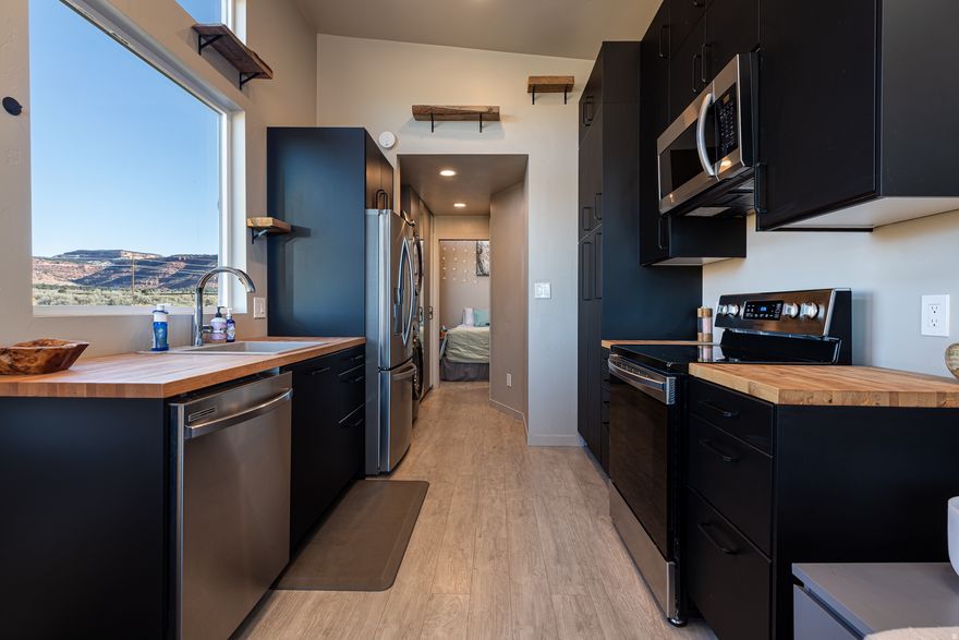 5 Acres with Sweeping Red Cliff Views | Zoned R-5 | STR-Friendly - Experience the beauty of Southern Utah from this stunning 5-acre parcel showcasing unobstructed red cliff views and endless possibilities. This property is fully equipped with electric, water, and a 1,500-gallon septic system, making it ready for your dream build. A sleek, modern RV (or tiny home per what lenders say) already sits on the property - perfect as a place to live comfortably while you build your future home at which time you can sell it and use the cash toward your stick-built home. Zoned R-5, this parcel allows two site-built homes of equal, offering exceptional flexibility for a private estate, family compound, or investment opportunity. A single short-term rental is permitted, and with a county conditional use permit, 2 residences can operate as dual STRs - a good option for those seeking income potential in a highly desirable area. Enjoy privacy, serenity, and the breathtaking natural scenery making this region so special - all while being minutes from town and outdoor adventure. Buyer to verify all. Separate mortgages may be required for the RV home and the land