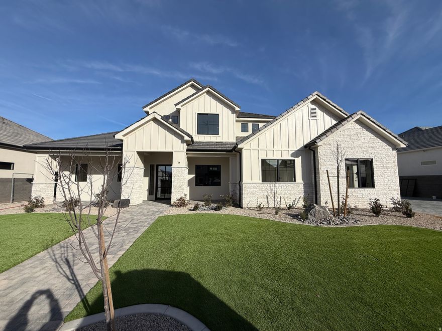 Beautiful home in Sycamore Village less than 10 minutes from Sand Hollow Reservoir, off roading, and golf course. Almost 39' RV garage with 14' wide and 13' tall door. Backyard oasis with a salt-water pool, lush palm trees, artificial turf, & paver patio. Open-concept floor plan with large picture windows that flood the home with natural light, tall ceilings throughout & 8' doorways with a second bedroom + an office on the main. Chef's kitchen featuring Caf appliances, built in fridge/freezer, luxurious quartz countertops, and butler's pantry. Spacious primary suite showcases exquisite tile work, dual vanities & his/hers closet. Upstairs there is a second massive living room & laundry room.