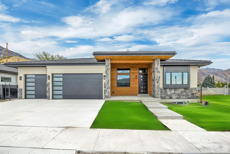 Newly priced at $1,375,000 ($25,000 below appraisal)-this move in ready Abbey Road stunner is your shortcut to the Utah lifestyle with built-in value.  Built by Whitehaven Builders at the base of Mt. Timpanogos, this mountain-modern home is designed for people who want more time on the trail, in the canyon, or on the slopes-and less time managing a yard.  Enter through the cedar-covered porch and glass front door into a bright, open great room with 13' vaulted ceilings and a dramatic wall of windows that frame east-facing mountain views. Morning sun spills across the patio-perfect for relaxing before hopping on the Murdock Trail, just outside the neighborhood. The chef's kitchen keeps everyone together with a generous quartz island, Bosch appliance package, gas cooktop, and a hidden walk-in pantry that feels like a second kitchen-complete with a second sink and dishwasher for seamless entertaining.  The main-floor primary suite is a true retreat after big days outdoors, featuring a spa-inspired bath with a freestanding soaking tub and oversized shower, plus a custom closet with an island and washer/dryer hookups. A glass-doored main-floor office makes work-from-home feel polished and private.  Downstairs is built for downtime and performance: a spacious family lounge with kitchenette for game days, a tiered theater for movie nights, and a glass-enclosed gym with specialty flooring and its own climate control for year-round training. Two additional bedrooms (including one ensuite), a full bath, oversized laundry, cold storage, and a fun under-stair play nook round out the lower level.  And because adventure should be the priority, the home is loaded with low-maintenance, high-efficiency upgrades: a fully finished, insulated 3-car garage with epoxy floors, hot/cold water, EV outlet, and smart openers; energy-saving systems with dual furnaces, instant hot water, and AprilAire filtration; plus durable stucco/stone/cedar exterior and a 75-year Bar-Tile roof. The landscaped, fully fenced yard includes approx. 0.17 acres of limited common area-less to maintain, more space to enjoy.  The $125/month HOA covers front and back lawn mowing and snow removal (driveway + sidewalks), plus community green space and a pickleball court. You're minutes from Harmons, University Place, Provo Canyon, and I-15-with hiking, biking, skiing, and everyday convenience right where you want it.  Special Financing Available: Seller finance or lease-to-own options with 20% down, 6.99% interest, 30-year amortization, and a 23 year balloon. Ask for details on these flexible terms and how they can help you secure this Abbey Road lifestyle now.