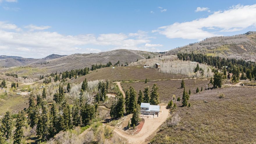 *Your Great Escape Awaits* Come enjoy your mountain retreat this summer in the desirable Skyline Mountain Resort! Situated near the top at approximately 8,400 feet elevation, this cabin offers breathtaking views of the valley and surrounding peaks. Most furnishings are included or negotiable, allowing you to potentially move right in and start enjoying your getaway. Explore 35+ miles of trails for ATV adventures in the summer and snowmobiling and hunting in the winter. Resort amenities include a swimming pool, golf course, and tennis/pickleball courts. The property features a private water tank filled from a nearby source (less than a mile away) and a brand-new electric water heater. Don't miss this chance to own your own slice of mountain paradise!