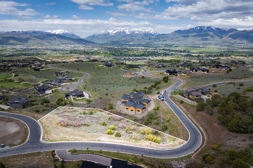 Discover one of Red Ledges' premier custom homesites - offering expansive panoramic views, a gentle build site, and an unbeatable combination of privacy and access. Nestled on an elevated street, this lot captures stunning vistas of the Wasatch Back and is bordered by open space, creating a peaceful mountain setting that feels both secluded and connected. With over one and a quarter acres of land, there's ample room to design and build your ideal mountain retreat while still enjoying proximity to the community's extensive amenities. Just minutes from the Red Ledges Village Center, owners have easy access to the Jack Nicklaus Signature Golf Course, tennis and pickleball courts, the fitness and wellness center, equestrian facilities, and miles of hiking and biking trails. And even better, the upcoming Mountainside amenity, featuring Red Ledges' next dining experience and pool, is a short walk up the road. In the winter, enjoy quick access to Deer Valley Resort - just 15 minutes away via our Club shuttles - where Red Ledges members benefit from three private ski amenities for a seamless on-mountain experience. A Red Ledges Club membership is required with this property; a Golf membership is available with a separate deposit. This is a rare opportunity to secure a homesite that blends year-round recreation, privacy, and elevated living in one of Utah's most exceptional private communities.