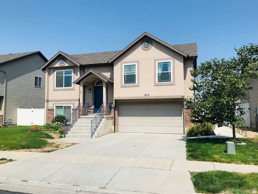 Beautiful home in North Salt Lake with large patio, deck and garden area. This 3-bedroom, 2-bath residence offers outdoor living with a spacious deck, expansive patio, and a dedicated garden area featuring planter boxes and peach trees. A fire pit creates a pleasant focal point for gatherings, while a two-car garage and separate shed provide ample storage. Comfortable indoor living connects seamlessly to the outdoor spaces, making this home well suited for anyone seeking a blend of convenience and outdoor enjoyment. Central air and an open floor plan. Kitchen island with french door fridge, dishwasher and a built in microwave. Home has washer and dryer hookups. Large fenced backyard with deck and an oversized patio. Fire pit, shed, fruit trees, raised beds for garden and more. 2 car garage.  Square footage figures are provided as a courtesy estimate only. Buyer is advised to obtain an independent measurement.