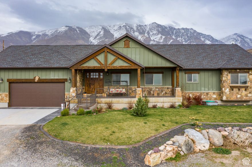 Nestled in the serene landscapes of Santaquin, Utah, this picturesque estate sits majestically on 12 sprawling acres of pristine land while having 2 custom homes on the property. Boasting breathtaking views of the surrounding mountains and valleys, this property offers a perfect blend of tranquility and natural beauty. The main home has a spacious interior featuring 8 bedrooms and 5 bathrooms, custom cabinetry and woodwork, custom light fixtures, theater room, and the possibility of a full second kitchen downstairs! While the outdoor space includes Large porch and deck, basketball court, outdoor play area, and outdoor barn, making it an ideal retreat for both relaxation and outdoor activities. Whether you're seeking a peaceful escape or a place to create lasting memories with family and friends, this remarkable estate offers the ultimate in rural luxury living.  In Addition, there is a beautiful guest home ( 3 beds, 2 bath) on property, perfect for family and guests to stay while soaking in the breathtaking views of the property. There is a wonderful opportunity for rental income on the guest home. The area is BOOMING with development!! The property sits on the Santaquin bench which is in Very High Demand! This is the perfect land for PRIME development.  This is a MUST see property! Square footage figures are provided as a courtesy estimate only and were obtained from seller.  Buyer is advised to obtain an independent measurement. Buyer to verify all information.