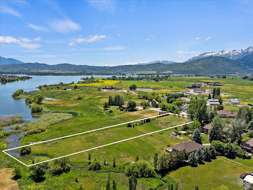 An extraordinary opportunity awaits in the heart of the Ogden Valley with this rare 1.95-acre buildable parcel in Eden, Utah. Properties of this caliber seldom become available, offering a unique blend of natural beauty, recreational access, and modern readiness.  With water, power, gas and fiber available at the street, this lot is ready for your custom residence, private retreat or legacy estate. The property features mature landscaping and has a long history as an organic vegetable farm with no pesticides used for over 25 years. Set against a stunning backdrop, the property showcases panoramic views of Pineview Reservoir, Powder Mountain, and Snowbasin Resort. A stream runs through the property, adding a serene ambiance and allowing kayak access directly to the lake when water levels are high. Outdoor enthusiasts will appreciate the location, just a short walk to the Pineview Pathways paved trail, which offers miles of biking and walking routes surrounded by nature. The lot's proximity to world-class ski resorts, pristine lakes, and scenic hiking trails makes it ideal for those seeking a balance of tranquility and recreation.  Large, buildable lots in this sought-after area of Eden's lakeside corridor are exceedingly rare. Combining natural beauty, established landscaping, and breathtaking views, this property presents a once-in-a-generation opportunity to build in one of Utah's most picturesque valleys. Whether you envision a full-time mountain home or a vacation retreat, this lot on a quiet cul-da-sac delivers the perfect harmony of serenity, adventure, and convenience. Weber /Morgan Perc for septic system has been completed.