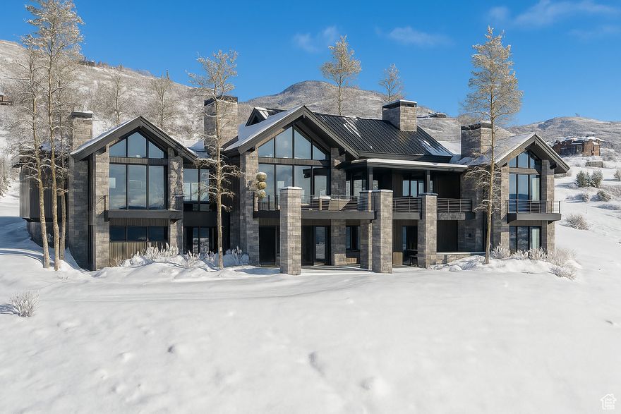 Welcome to 10098 N Himmel Court, a stunning new construction residence in the exclusive Velvaere ski community at Deer Valley East Village-Park City's newest hub for world-class skiing, dining, and year-round recreation. Situated on a rare ski-in/ski-out 0.92-acre parcel at the end of a quiet cul-de-sac, this 8,031 sq ft mountain retreat offers the ultimate in luxury, convenience, and design.  Thoughtfully designed by The Curtis Group, expertly built by H2 Homes, and elegantly styled by Olsen Home Design, every detail of this home reflects quality and craftsmanship. The open-concept floor plan features two spacious bedroom suites on the main level and four additional bedrooms on the lower level, including a dedicated bunk room-all with private en-suite bathrooms, perfect for hosting family and guests.  An expansive layout flows effortlessly into outdoor living spaces, including a generous back deck and a covered patio with a hot tub-ideal for soaking in the surrounding alpine beauty. Enjoy stunning views of the Jordanelle Reservoir while entertaining or unwinding after a day on the slopes.  The lower level is designed for fun and relaxation with a large rec room and wet bar, a home theater, a fitness area, and a dedicated ski room with built-in storage-perfect for aprs-ski gatherings. With direct ski access and a premier location in Deer Valley's newest village, this rare offering blends elevated mountain living with unparalleled access to Utah's most exciting resort destination.