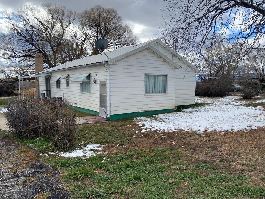 Square footage figures are provided as a courtesy estimate only and were obtained from recent appraisal. Buyer is advised to obtain an independent measurement. This listing also includes tax # 02-1701.   Enjoy peaceful country living only minutes from town.  Three bedroom, 2 bath one-level home on 3.51 acres.  Property includes 2 garages.  The large garage/shop is 800 sq. ft with two large doors. This building also has an attached shed with is 520 sq. ft.  The smaller older block garage is 621 sq. ft.   These garages offer ample space for all your needs.  In the rear of the property is 2.51 acres for all you farm animals.  Best of all this home comes with water shares and mineral rights.  This charming home is perfect for those seeking privacy and a slower pace without sacrificing connivence.  Property being sold AS IS.