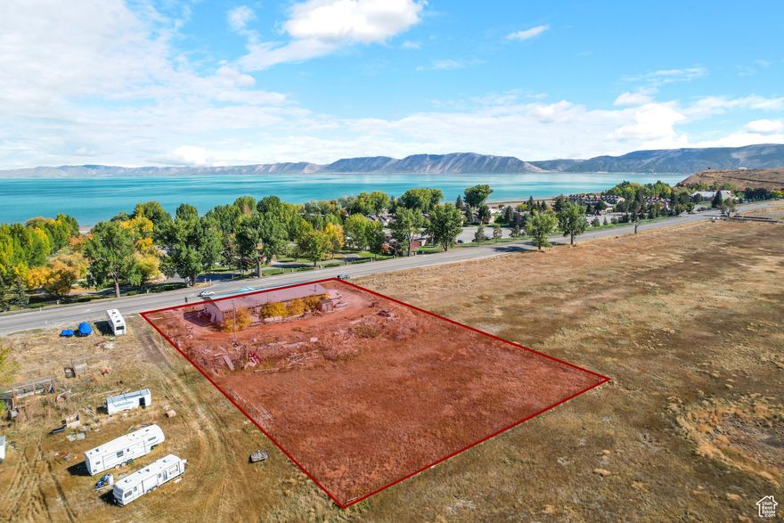 Prime Commercial Property on south Bear Lake Boulevard! Incredible opportunity to own a 5,557 sq. ft. commercial building on 1.5 acres in a high-traffic, high-visibility location directly across from Ideal Beach Resort and Sun Outdoors Bear Lake. This solid block building offers excellent functionality with 200 feet of Bear Lake Blvd frontage, the lot is 327' deep, giving you plenty of room to add on or storage area or more parking. Features include a 1,436 sq. ft. finished office/showroom, a leased commercial laundry for additional income, and a large heated garage/storage area with two 10' x 12' overhead doors. The laundry area has its own additional 10' x 12' overhead door. All utilities are in place, including 3-phase power and a 1,000-gallon propane tank for heat. The layout provides flexibility for a variety of commercial, office or retail uses. With Bear Lake experiencing steady year-over-year growth from both permanent residents and vacationers, this is a prime investment opportunity in a thriving resort community.
