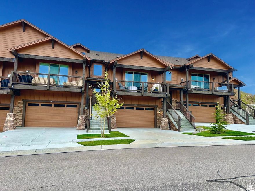 This newly built 2022 townhome offers breathtaking views of Deer Valley from its main level, front covered balcony, & upstairs loft. A more rare to find 4 bedroom, 4 bath layout with no backyard neighbors enhancing your enjoyment & privacy of your home; not to mention it has a covered patio that could be perfect for a hot tub or fire pit lounge.  There are 3 levels of bright, abundant, & open space!  The main level has a spacious living room with a cozy fire perfect for cuddling up & looking out at the stunning mountains or opening the sliding door to walk out to your darling covered balcony to enjoy the incredible views, & have a quaint fire pit or bbq.  Also on the main level is a sizable dining area behind the couch & large kitchen with about an oversized island, pantry, several viking appliances, & reverse osmosis! You will find 2 bedrooms on the main. One with a walk-in closet & ensuite bathroom that walks out to the back covered patio & yard. Also one with a separate bathroom sharable for guests.  Upstairs is a huge loft suitable for a bedroom, office, pre-wired theater room; any of which your heart desires! To make it even more swoon worthy its complete with a walk-in closet & private en-suite bathroom with an oversized shower.   The lower level boasts high ceilings for a luxury expansive feel. It has a second living room, separate full bathroom, large bedroom currently shown as a gym, along with a walk-in closet!  Did we mention the oversized 2 car garage with an entry perfect for lockers, a bench, shoes, coats, & more? No home is complete without storage, you will be delighted to find a large under the stairs storage closet along with use of the additional space in the garage for your needs. Located about 7 minutes to historic Park City, 5 minutes to East Village at Deer Valley & Jordanelle Reservoir, 3 minutes to the highway, 10 minutes to Kimball Junction and 35 minutes to Salt Lake City. You'll find yourself right in the middle of where you want to be! It has ease of access to several trails for hiking & biking in & around the community providing easy access to nature and year-round recreation. This is mountain living at its very finest.   Currently offered without furnishings.  Home can be negotiated to be sold fully furnished if Buyer desires. Home is scheduled to be staged with all new high end furnishings from HELM.