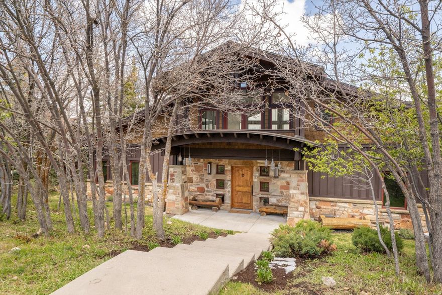 This timeless corner-lot home in the Aerie is fully move-in ready and ideally located just minutes from Park City's Main Street and world-class ski resorts. Positioned between Aerie Drive and Aerie Court, the property offers privacy, direct access to a nearby trailhead, and sweeping northeastern views.  Designed to capture bright light all year round--no matter the season--the home features soaring ceilings and expansive windows that fill every living space with natural light while framing stunning mountain vistas.  The open-concept floor plan is perfect for both everyday living and entertaining, with a spacious great room and a chef's kitchen complete with custom cabinetry, a Sub-Zero refrigerator, and a Wolf double range with dual ovens.  The main level includes a dedicated office and two bedrooms with ensuite bathrooms. The private northern wing serves as a true retreat, offering its own patio, two walk-in closets, a laundry area, and a generous spa-like bathroom.  Upstairs, guests and family will enjoy a separate living area that opens to an east-facing deck, along with two additional bedrooms, each with ensuite baths.  The lower level features a well-appointed mudroom with custom ski lockers, ideal for mountain living. An oversized three-car garage provides ample room for vehicles and includes additional storage space for all your recreational gear.