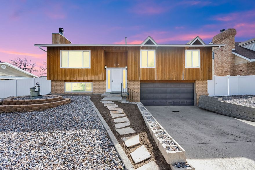 Welcome to your beautifully updated retreat where modern upgrades meet comfort and style. Step inside and fall in love with the newly renovated kitchen, designed for both everyday living and effortless entertaining. It features soft-close cabinetry, all-new appliances (included), a reverse osmosis water purifier, and stylish finishes. The open-concept layout flows seamlessly into the dining area and inviting family room, where a cozy wood-burning fireplace creates the perfect gathering space. Natural light pours through brand-new tinted windows, highlighting the beautiful engineered hardwood floors and thoughtful upgrades throughout the home.  Enjoy the ambiance created by recessed lighting, dimmer switches, modern fixtures, updated plumbing, and significant electrical improvements. Step outside to two expansive decks, perfect for relaxing mornings, sunset dinners, or entertaining guests. The spacious primary bedroom offers a peaceful retreat with a private ensuite bathroom featuring a remodeled shower with customizable temperature settings. Two more bedrooms and a second full bathroom on the main level add convenience for family and guests. Downstairs, the basement provides additional living space with a comfortable family room, a fourth bedroom, and a laundry room/bath combo. As a bonus, brand-new LVP flooring has already been purchased and will be left for the new owners. Outside, the property continues to impress with a large two-car garage with programmable opener, walkout access to the basement and backyard, a 32-ft RV pad, and additional side parking. The home also features new rain gutters, HVAC replaced in 2021, and a roof replaced in 2015. Backyard improvements are already underway with new vinyl fencing, a retaining wall, and a brand-new shed. The remaining yard is a blank canvas ready for your dream garden, fire pit, or patio oasis. Wonderful neighborhood, close to schools,  transit, walking and biking trails!!!  With extensive upgrades, flexible living space, and wonderful views, this home is the perfect blend of move-in-ready convenience and future potential. Come see it for yourself and imagine the possibilities!