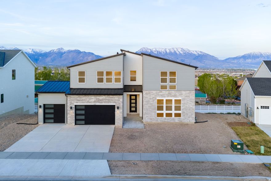 Beautifully designed home featuring a gourmet kitchen, large windows, abundant natural light, and a covered deck perfect for relaxing or entertaining while enjoying mountain and valley views. The thoughtfully designed floor plan includes a main-floor primary suite with a spa-like bathroom featuring a standalone soaking tub, separate vanities, large walk-in shower, and an oversized walk-in closet, plus a main-floor office or additional living room for flexible use. Upstairs offers three spacious bedrooms, two full bathrooms, and a versatile loft area ideal for a second living space, playroom, study zone, or even a home gym.  The fully finished basement adds even more room with three additional bedrooms and two bathrooms, creating excellent space for guests, multi-generational living, or hobbies.  Located in a quaint neighborhood near shopping, dining, and entertainment, this home combines comfort, space, and convenience with beautiful views and ideal function.