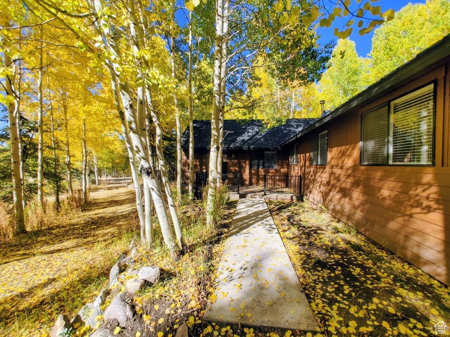 Like-new cabin located at the top of Timber Lakes on a large 1.50 acre corner lot that borders 54 acres of common area with hiking trails and river access. As close to a brand-new build as you can get without spending the money. Convenient rambler layout keeps everything on one level with no stairs. Large private master suite located on the north side of the cabin opposite of the 3 spacious guest rooms. Front driveway is a convenient circular driveway that leads to the front door for guests and the second, rear driveway is large for plenty of parking and is cleared out for a detached garage. Majority of this aspen-filled lot is flat and useable, including your own private atv/snowmobile loop to keep the littles having fun off the main roads.