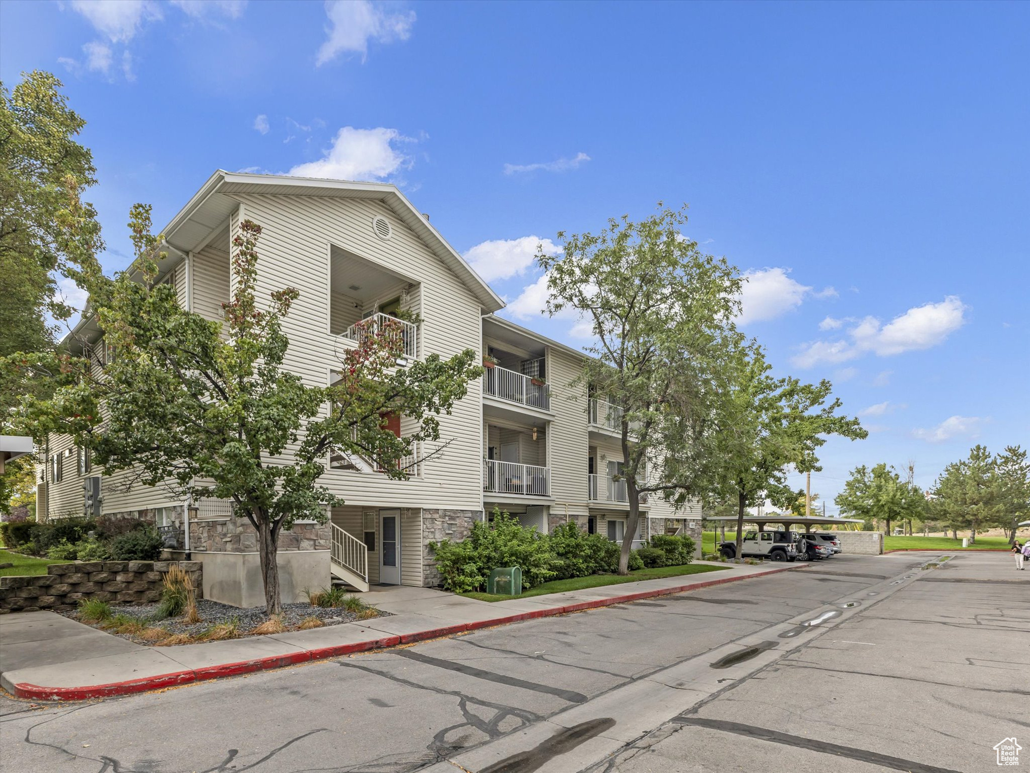 Discover stylish and convenient living in this rarely available main floor condo nestled in the highly desirable River Run Community. Perfectly situated, this home offers unbeatable central access-just minutes from the Jordan River Parkway, freeway entrances, top-rated schools, shopping, dining, parks, golf courses, and scenic trails. It's also within walking distance to the new Olene Walker Elementary School. This light-filled and inviting unit features a spacious, open floor plan enhanced by rich hardwood flooring throughout. Complete with three generously sized bedrooms and two full bathrooms, this home effortlessly combines comfort with function. The heart of the home is the kitchen, equipped with white solid surface countertops, stainless steel appliances, a smooth top range, pantry, and included refrigerator-perfect for both everyday meals and entertaining. The great room provides an ideal gathering space, complemented by a cozy gas fireplace for winter warmth and central air conditioning to keep cool in the summer. Retreat to the primary suite, which features dual closets, a beautifully updated double vanity, and a relaxing garden tub. Step outside to your private patio, accessible from both the primary bedroom and the great room. Additional storage closets off the patio offer a practical solution for storing bikes or outdoor gear. Enjoy a vibrant lifestyle with access to a wide range of community amenities, including a swimming pool, clubhouse, gym, tennis courts, volleyball, playgrounds, and picnic areas. Stroll through the beautifully maintained grounds or socialize with neighbors in this welcoming community. Additional perks include one dedicated covered parking space, ample open parking, and a low HOA fee that covers cable, water, sewer, trash, snow removal, landscape maintenance, and community insurance. This turnkey condo is a rare gem-don't miss your chance to call River Run home!
