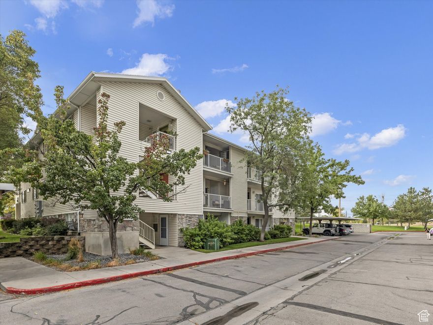 Discover stylish and convenient living in this rarely available main floor condo nestled in the highly desirable River Run Community. Perfectly situated, this home offers unbeatable central access-just minutes from the Jordan River Parkway, freeway entrances, top-rated schools, shopping, dining, parks, golf courses, and scenic trails. It's also within walking distance to the new Olene Walker Elementary School. This light-filled and inviting unit features a spacious, open floor plan enhanced by rich hardwood flooring throughout. Complete with three generously sized bedrooms and two full bathrooms, this home effortlessly combines comfort with function. The heart of the home is the kitchen, equipped with white solid surface countertops, stainless steel appliances, a smooth top range, pantry, and included refrigerator-perfect for both everyday meals and entertaining. The great room provides an ideal gathering space, complemented by a cozy gas fireplace for winter warmth and central air conditioning to keep cool in the summer. Retreat to the primary suite, which features dual closets, a beautifully updated double vanity, and a relaxing garden tub. Step outside to your private patio, accessible from both the primary bedroom and the great room. Additional storage closets off the patio offer a practical solution for storing bikes or outdoor gear. Enjoy a vibrant lifestyle with access to a wide range of community amenities, including a swimming pool, clubhouse, gym, tennis courts, volleyball, playgrounds, and picnic areas. Stroll through the beautifully maintained grounds or socialize with neighbors in this welcoming community. Additional perks include one dedicated covered parking space, ample open parking, and a low HOA fee that covers cable, water, sewer, trash, snow removal, landscape maintenance, and community insurance. This turnkey condo is a rare gem-don't miss your chance to call River Run home!