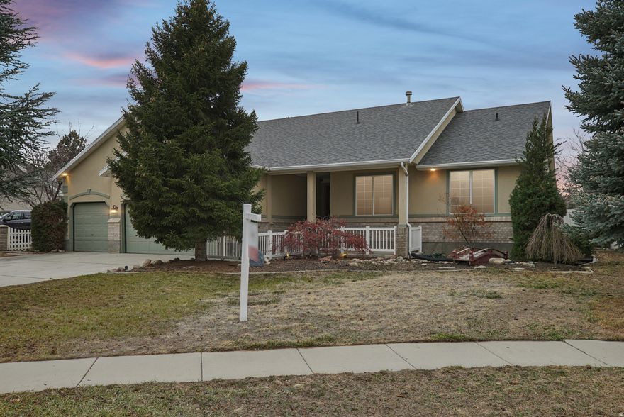 MULTIPLE OFFERS RECEIVED!!! HIGHEST AND BEST DUE TUESDAY DECEMBER 23RD BY 3:00PM!!! Rambler-style home in South Jordan with the potential for single-level living! This home features vaulted ceilings and fresh new carpet on the main level. The living area is highlighted by warm cherrywood floors, a cozy fireplace, and a large office perfect for working from home. The kitchen is beautifully appointed with granite countertops, stainless steel appliances, and a gas stove.  The spacious primary suite includes a walk-in closet and an ensuite bathroom with a garden tub and separate shower. Downstairs you'll find another fireplace, providing a comfortable retreat for gatherings and relaxation.  Additional highlights include a three-car garage with storage racks, a private deck, and mature landscaping that creates a sense of privacy and seclusion. This home combines comfort, functionality, and timeless appeal-schedule your showing today!