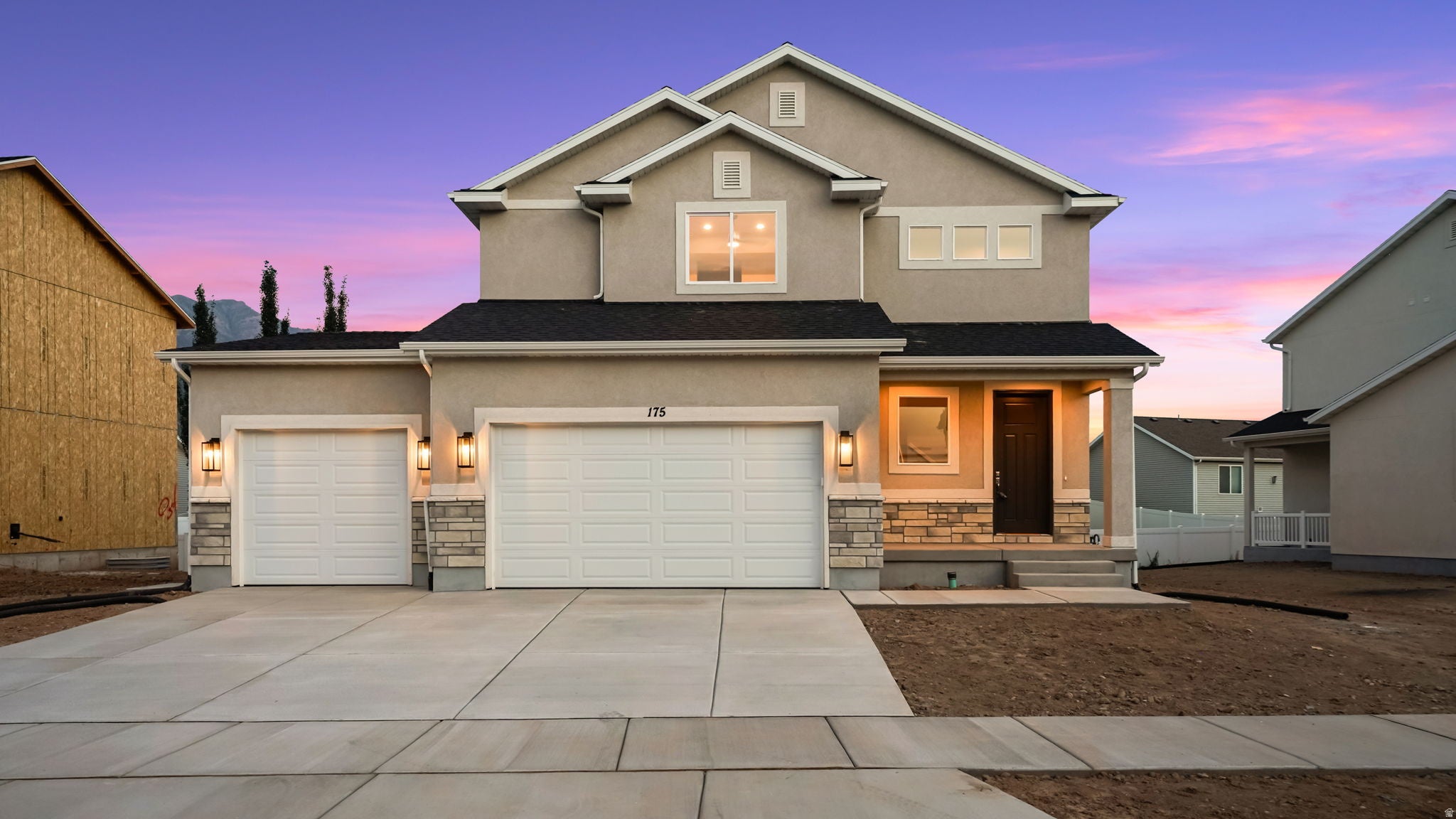 Contemporary two-story residence featuring a stucco exterior and stone veneer accents