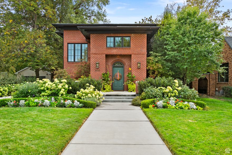 Custom designed and built in 2014, this luxurious home features timeless proportions, rich materials, and refined details inspired by Chicago brownstones and 1920s elegance. Classic styling and modern comforts in Salt Lake's prestigious Country Club neighborhood.  How does it achieve rich styling and contemporary convenience? It begins with a professionally designed and landscaped garden that leads to a massive front porch and a vaulted entry with custom tile and warm oak floors. Guests are welcomed by a beautiful powder room and a generous coat closet. The main floor is anchored by a glass-enclosed den that still feels private as it overlooks the great room. The chef's kitchen features Thermador appliances, honed black granite, and natural quartzite, with sky-high cabinets and a farmhouse sink. Designed for indoor-outdoor entertaining, French doors open to a large patio. Hide the mess from guests in the butler's pantry where the black granite continues. Floating stainless shelves bring the outdoors in and are perfect for houseplants. The side entry-where homeowners realistically come and go-is a practical spot to unload Costco runs, skis, and backpacks into built-in lockers.  Wind down in the primary suite and choose your self-care: soak in the hot tub on the private balcony, enjoy the steam shower, or take a long bath-this suite has it all. No expense was spared.  The basement continues the generous vertical scale with high ceilings, two additional bedrooms, a storage room with custom shelving, and a workroom.  Architectural lighting highlights a professionally designed and maintained .38-acre lot with border gardens, mature trees, full irrigation, a boxed vegetable garden, fruit trees, a raspberry patch, a removable chicken coop, and a garden shed. Something blooms every season. If the long driveway feels imposing, rest assured it is plumbed for radiant heating (pipes are visible in the basement utility room) and awaits installation of a boiler. The detached garage offers extra depth with a shop, mini-split HVAC, conduit for a whole-home generator, and sufficient voltage to charge an EV.  Walk to Sugarhouse Park, the Salt Lake Country Club, and the Salt Lake Swimming and Tennis Club. Recreate closer to home at the new Roselyn Heights Sports Complex with tennis courts, a turf field, and park just steps from your back door.   Square footage figures are provided as a courtesy estimate only and were obtained from tax data.  Buyer is advised to obtain an independent measurement.