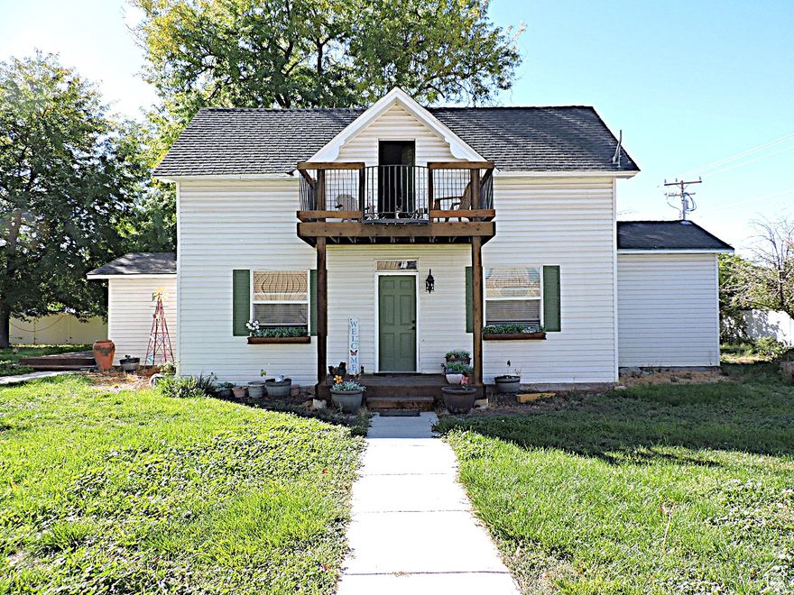 Timeless Beauty with charm throughout, this home offers both comfort and functionality. The quaint living room flows into the dining area and kitchen, providing an ideal layout for family living and entertaining. The main level features the primary bedroom with a walk-in closet, as well as a conveniently located bathroom and laundry room. The upper level includes two additional bedrooms, a full bathroom, and access to a balcony. The large, fenced yard offers ample shade and a patio area perfect for outdoor enjoyment and entertaining. Square footage figures are provided as a courtesy estimate only.