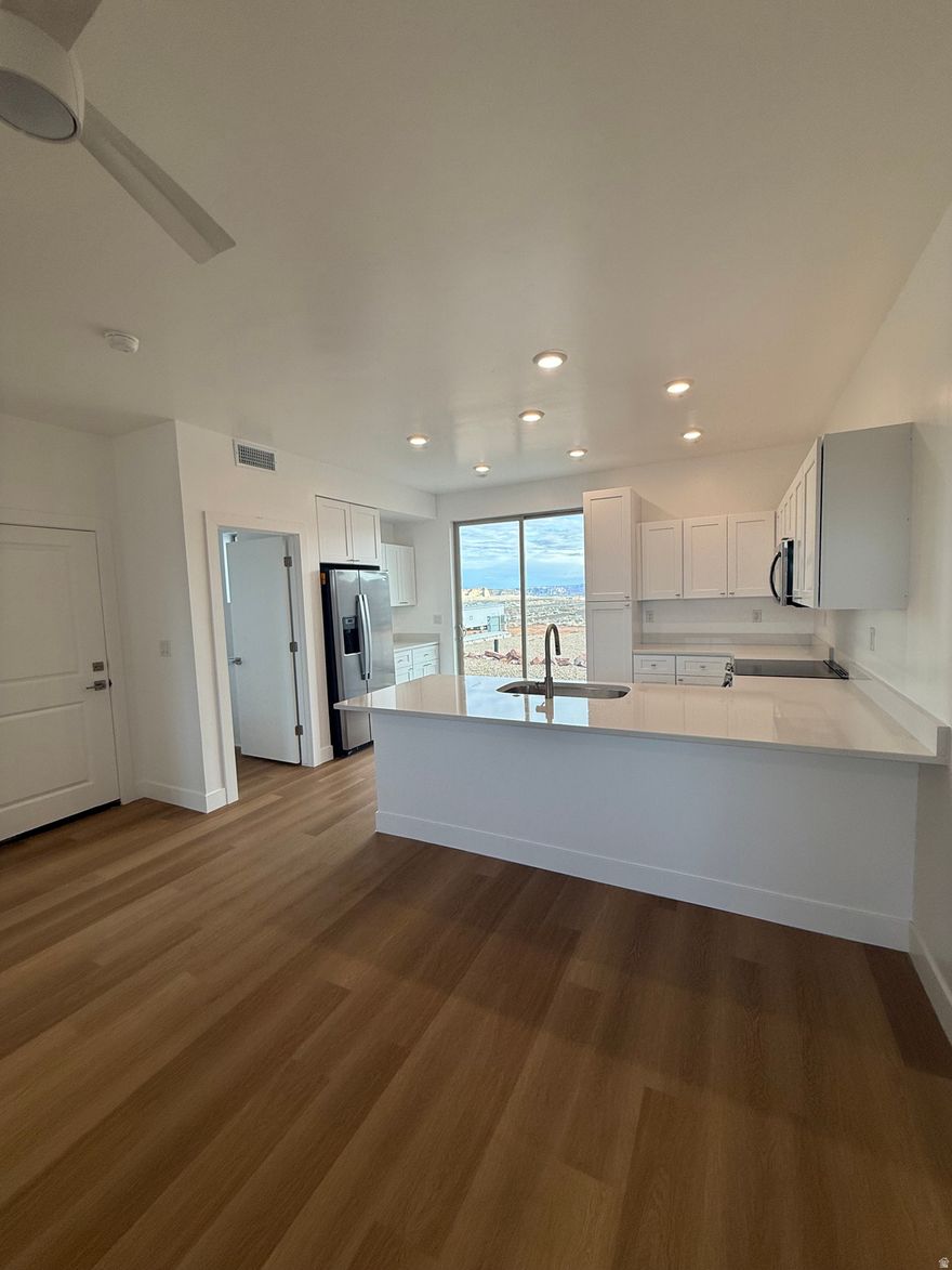 These townhomes welcome people with an open concept floor plan that highlights quality details with plenty of standard features. Bask under 9+ foot ceilings where you can enjoy meals at the breakfast bar or on the deck overlooking the lake and beautiful desert landscape. Lone Rock View Townhomes are perfect for your full time, investment, or vacation home for your getaway to Lake Powell, off roading and other outdoor adventures. When you purchase Lone Rock View Townhomes you get standard features included with the build such as solid surface countertops, luxury vinyl floors and much more