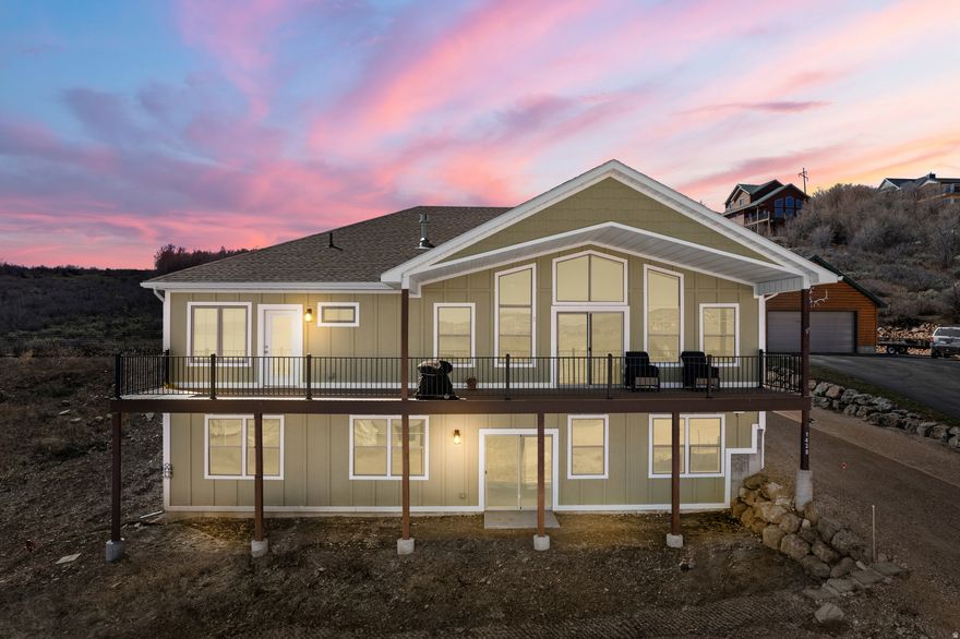 Move-in ready Custom two-level home, built in 2022, on .28/acre lot. 3,982 sq. ft. Beautiful, unobscured view of Bear Lake with pasture and rolling hills in the foreground. Home is 1/2 aerial mile from the lake shoreline and only a 2-mile drive to Bear Lake Marina. The exclusive Swan Creek Village community is gated with well-maintained roads, central water and sewer. Swan Creek values it's tranquil character and as such, does not allow short term (daily or weekly) rentals. Swan Creek Village does allow rentals for 30 days or more, monthly rental potential $2-4K/mo. Heat, hot water, fireplace and range/stove are propane. Central forced air heating and air conditioning. Quality vinyl Thermopane windows and sliding doors. 3 outside Therma-Tru insulated doors, digital electronic deadbolts on 2 entry doors. LVP flooring in all rooms except bedrooms, which are carpeted. Solid knotty alder 8' interior doors and knotty alder trim. All cabinet doors & drawers are self-close. Recessed LED lighting throughout the home. Decorative ceiling fans in great room and bedrooms. Aluminum gutters and downspouts. Smart thermostat, remote App on cell phone. Great Room has cathedral ceiling, front glass gable end facing lake with sliding door to deck. All windows have electronic UV sunshades. In-floor electric outlet. Large living area with cultured stone front gas fireplace with raised hearth and full-length knotty alder mantel Large kitchen with granite counters and backsplash, granite island with 4 place cantilevered eating counter, knotty alder cabinets and small pantry. Revolving 2 tier pot & pan storage in corner of island. Dual waste bin slide-out under counter. GE Slate refrigerator, dishwasher, gas range/oven, microwave with exhaust range hood and a sink disposal. Dining table area seats 6 in addition to 4 place seating at counter. Main Bedroom: with lake view through large window and glass door to deck. Ensuite bath, glass enclosed decorative tile shower, dual commode rooms, knotty alder vanity with storage, granite counter with backsplash, dual sinks, oval mirrors, decorative lighting and glass medicine cabinet. Very large master closet with dressing table and glamour lighting. Very large mudroom with washer and dryer, granite counter with backsplash, stainless sink, knotty alder cabinets and under-counter LED lighting, custom knotty alder 4 position built-in hall rack wall with bench, shelves and coat hanging area. Linen/storage closet and a separate broom closet. 52' Trex deck facing lake, off great room with insulated slider and 32' roof covering. Wrought iron view railing. Covered front entry and wide entry foyer. 2 car attached garage with 2 clerestory windows, insulated garage door, Genie Aladdin Wi Fi garage door controller with batteryback-up. 240 Volt EV level 2 charging outlet. Concrete garage apron and front walk. Space on side of garage for RV or boat. Lower Level is approximately 25% completed, fully insulated, framed, rough plumbing and electric for 4th & 5th bedrooms, large family room, full bathroom, kitchenette & dining area and cold storage room. Additional unframed area for another bedroom and bath. Sheet rocked utility room with gas furnace, A/C, hot water heater, 200 Amp electric panel and 8' knotty alder door. Sheet rocked closet under stairs with 8' knotty alder door. Insulated vinyl windows in 2 front bedrooms and front family room has insulated vinyl slider with 6' concrete pad outside. Full 9-to-10-foot ceilings throughout, sheet rocked split staircase with landing, decorative wood handrails and banister. Furnishings are attractively priced for purchase and list will be provided prior to sale. Come make this your Bear Lake home!