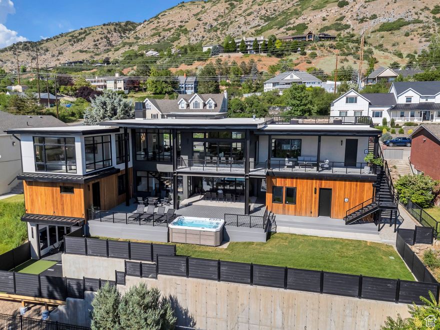 Experience modern luxury in this stunning Parade of Homes showcase by 10X Builders in Provo. Designed for comfort and entertainment, this home features incredible valley views, a private spa room with cold plunge and sauna, a swim spa, and a fully equipped workout room.  Each bedroom has its own en-suite bath, and the primary suite includes heated floors for year-round comfort. Enjoy movie nights in the theater room, host guests in the bunk room, and take advantage of the separate 1 bed/1 bath apartment with private entrance.  Impeccably crafted with attention to detail, this home is where wellness, design, and functionality come together.