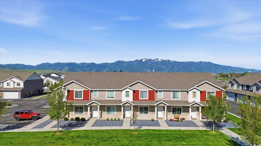 Beautiful townhome in the desirable Elk Mountain community! Features include an oversized, finished, 2-car garage, stainless steel appliances, granite countertops, upstairs laundry, under-stair storage, and a spacious primary suite with private bath. Front door opens to a large grassy area and playground. Community amenities include: clubhouse, pool, year-round hot tub, fitness center, spa, BBQ areas, and play spaces. Walking distance to Canyon Elementary, Mountain Crest HS, Blacksmith Fork Park, and free public transit. Park across the street offers pickleball, basketball, disc golf, baseball, trails, and more. Mountain views with easy access to hiking, fishing, and biking in Blacksmith Fork Canyon.