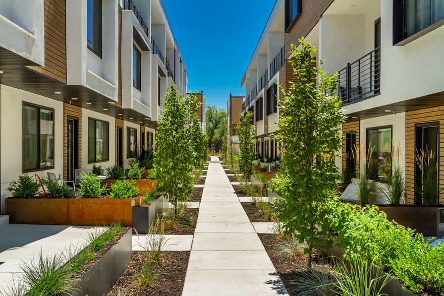 Welcome to Opus Green. Experience the perfect harmony of modern comfort and environmental stewardship. Opus Green Townhomes offer a range of floor plans, including 2 and 3-bedroom townhomes, designed with meticulous attention to detail. From the spacious great rooms and gourmet kitchens to the tiled showers and open stair railings, every aspect of Opus Green exudes sophistication and elegance for your comfort. This modern townhome community is all-electric with 9'7" cathedral ceilings, tiled showers and tubs with glass doors. Best in class, ductless, wall-mounted mini split air conditioners.  Quartz countertops and a one of a kind floorplan not seen before. This 2 bed 2.5 bathroom oasis will leave you green with envy. The 2 car garage with EV charging station, 1 touch smart home temperature control app and package storage/delivery service "Fetch Package", are just a few more added benefits to this zero emission environmental living townhome. Embrace a life of unparalleled comfort, elegance and fulfillment in the dwelling you've been longing for.