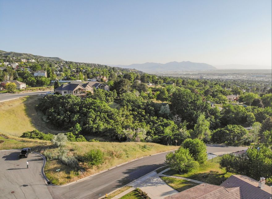 Close to 3/4 of an Acre in the hills of Bountiful. Amazing views, cul-de-sac, corner lot. Land is Zoned to be R4 (Residential 4) meaning 4 Units may be built PER 1 Acre (lot size is 8000SQFT/Dwelling). The property has potential to build an Amazing Custom home, 2 townhomes, twin homes (with mother in-law), or 2 residential homes. All utilities are at the road and is a good opportunity to subdivide and develop the land for a builder or take the project to the finish line *All info is provided as a courtesy Buyer to Verify all