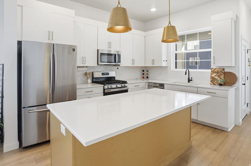 Located in Daybreak community in South Jordan, just steps from Highland Park and scenic walking and biking trails, this beautifully appointed rambler was built in 2022 by David Weekley Homes and includes a fully finished basement completed by the builder. Situated on a corner lot, the home offers open-concept, true single-level living with upgraded kitchen appliances, including a gas range, two-tone white and oak cabinetry with a contemporary aesthetic, brass hardware, and refined design details throughout. The gourmet kitchen serves as the heart of the home, featuring an extended sink-free island ideal for cooking, gathering, and entertaining. The spacious primary suite fits a king-size bed and sitting area. It is a private retreat with a spa-like ensuite bathroom and a spacious walk-in closet. The primary bathroom features dual sinks, a water closet, and an euro standing shower. The oversized garage features ceilings over 18 feet high, providing exceptional storage capacity to replace the need for off-site storage solutions. The fully finished basement includes a generous open area that can be divided into a living room plus a fifth bedroom, private office, or versatile flex space for guests. Meticulously maintained, the residence blends modern luxury style with everyday comfort in a layout that is both functional and elegant. Designer finishes, quality craftsmanship, and an extended floor plan create a seamless flow suited for both daily living and hosting. Enjoy the unmatched Daybreak lifestyle with access to parks, trails, pools, a lake, and year-round community events-making this one of Utah's most desirable master-planned communities. Square footage figures are provided as a courtesy estimate based on county records. Buyer is advised to obtain an independent measurement.