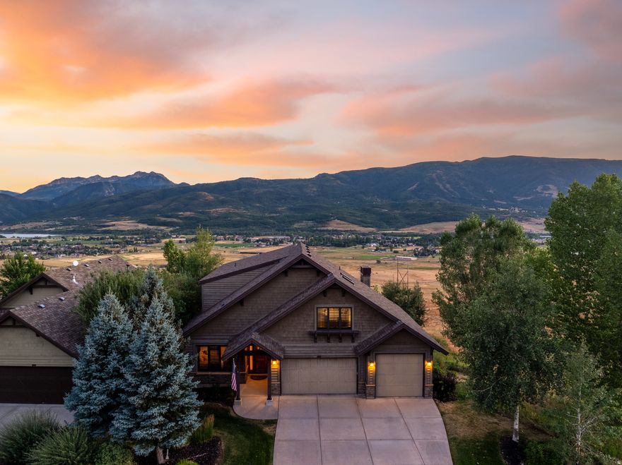 This Trappers Ridge gem underpromises and over-delivers. Modest from the street, it opens to one of the community's best lots-adjacent to open space with panoramic views of Nordic Valley, Pineview Reservoir, Ben Lomond Peak, and Snowbasin. Featuring one of the largest, most open floor plans in the neighborhood, the home offers expansive living and dining areas, a built-in bar, stone gas fireplace, and a custom antique white kitchen. Designed for entertaining, the kitchen includes a Wolf range, two Asko dishwashers, Sub-Zero refrigerator/freezer, copper farmhouse sink, large island, ice maker, and wet bar with Sub-Zero under-counter refrigerator/freezer. Two hot water heaters with recirculation provide instant hot water. The main level includes an en-suite bedroom and oversized laundry with alder built-ins, island, and sink. Upstairs, the primary suite features two walk-in closets and skylights, plus two additional bedrooms and a dedicated office with custom built-ins and granite workspace. The walkout basement offers a kitchenette, pool table, theater room with commercial projector, en-suite bedroom, two additional bedrooms, gym/flex room (ideal owner lockout), new high-end LVP, and abundant storage. Three separate gathering areas-one per level-provide flexible living space. Outdoor living shines with the neighborhood's largest custom 888 sq ft deck and a perfectly positioned hot tub below. Mature landscaping, two AC units, dual furnaces with separate controls, central vacuum, solid core doors, unique granite throughout, lighting updates, refinished 1-inch pine floors, fresh 2023 paint, and brand new exterior paint complete the package. Trappers Ridge amenities include a clubhouse, pool, hot tub, tennis courts, and lock-and-leave convenience. Zoned for nightly rentals and located minutes from Powder Mountain, Snowbasin, hiking, biking, and Pineview Reservoir, this property is ideal as a primary residence, second home, or investment opportunity. All property information, boundaries, and documents to be verified by buyer.