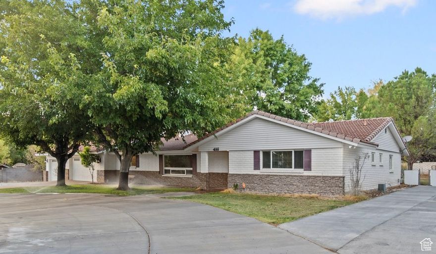 OPEN HOUSE Sat. 10/11, 11 am-1 pm. Car enthusiasts and hobbyists - Don't miss this rare find in the highly sought-after Bloomington Ranches neighborhood! This beautifully upgraded single-level home sits on  acre and offers the perfect blend of comfort, space, and lifestyle. The designer remodeled kitchen showcases custom tilework and masonry finishes, while two fireplaces and oversized rooms create a warm, inviting atmosphere.  The expansive attached 3 car garage space features an extra long bay that will house a long bed truck. The detached building features another 3-car garage in the front and an air conditioned shop in the back with a hydraulic car lift.  Outdoors, enjoy horse privileges, mature fruit trees, 3 shares of irrigation water included, a newly built gazebo, and plenty of room to relax or entertain. With golf courses and trails just minutes away, this property offers the best of both recreation and convenience. Don't miss your chance to own this unique home with unmatched features and location!