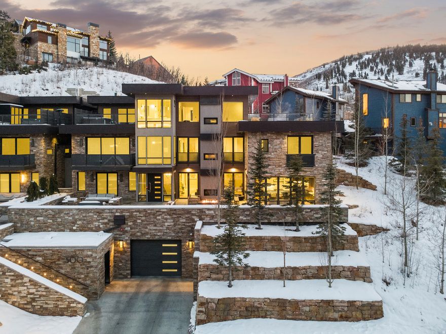 300 Deer Valley Drive Residence A presents a rare offering to own one of only four Roundabout homes meticulously designed by Constantino Grandjaquet, one of Utah's premier contemporary architects.  Perfectly situated just outside the incredible energy of historic Main Street, Park City, and lower Deer Valley, you are just moments from hitting the slopes at both Park City Mountain Resort via the Town lift and Deer Valley Resort at Snowpark Lodge. Every detail has been considered by the homeowners who curated a home in high style and exquisite taste, offering a thoughtful layout with top-shelf finishes and smart details.  This bespoke retreat is for the most discerning Buyer who values the unique beauty of the area, ease of access to multiple ski resorts, luxurious comfort, and the opportunity to own a home in one of the most sought-after mountain destinations in the world. Residence A is the largest of the four homes at Roundabout, measuring just under 5000 SF, offering 4 bedrooms and 5 baths, and private garage space for 4 cars, a rare offering in Old Town.  But this glamorous home is not about size and scale.  The refined details present layers of texture and warmth, and the WOW factor.  A chef's kitchen offers high-end appliances, 2 sinks, 2 dishwashers, gorgeous cabinetry, a walk-in pantry with a coffee station, and doors that open onto one of several terraces in the residence.  The dining area reflects the owner's exquisite taste, offering two full-sized Thermador wine coolers built into a gorgeous credenza with inlaid Italian glass.  The adjoining great room opens onto a terrace and has a fire feature perfect for entertaining 12 months of the year.  The Main Floor laundry room is stunning as is the powder room, complete with Cristallo Quartzite countertops. The floor plan is effortless, and all 4 floors are serviced by an elevator.  The luxurious primary suite is on the top floor, has a deluxe walk-in closet with laundry, a spa-like bath with steam shower, a sleek fireplace,floor-to-ceiling windows, a private rooftop terrace with a luxury hot tub and fire feature, which is the perfect place to view endless sunsets over Old Town Park City.  Additional notable features and amenities include: a study with mood lighting and Phillip Jeffries wall covering, a lounge/spa with walnut slab wall accents, a beverage cooler, and 80" TV.  There are 3 fireplaces, a mudroom off the heated garage, radiant heat throughout, including walkways and terraces,  AC, Finntech-air filtration system, Lutron control lighting, Audio system, wide plank wood flooring, gorgeous tilework, natural stone, and upgraded gallery, and dimmable lighting.  There are so many more features and amenities for this spectacular residence to list.  This is a home you will want to experience in person. You are invited!